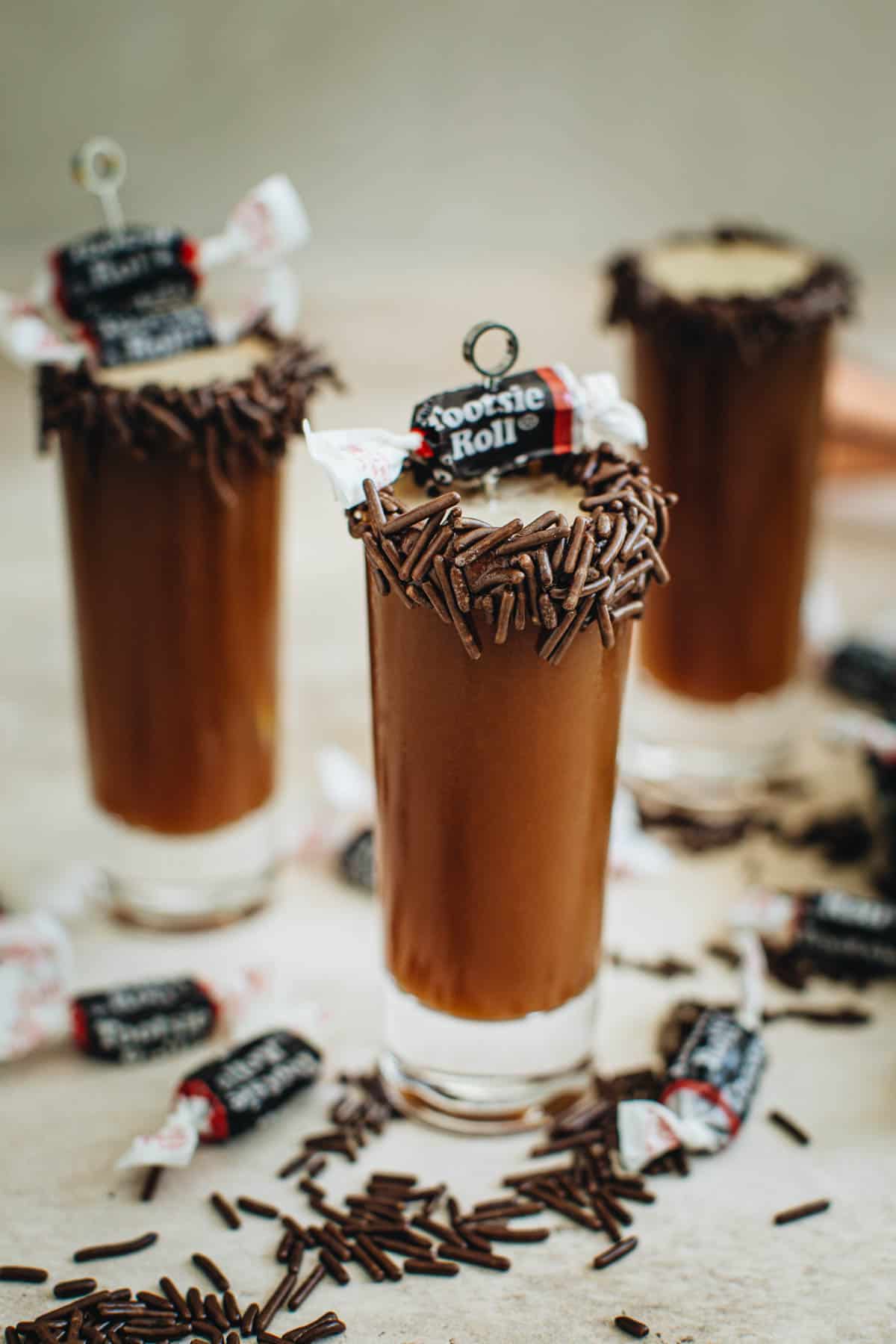 Tootsie Roll shots with a chocolate sprinkles covered rim.