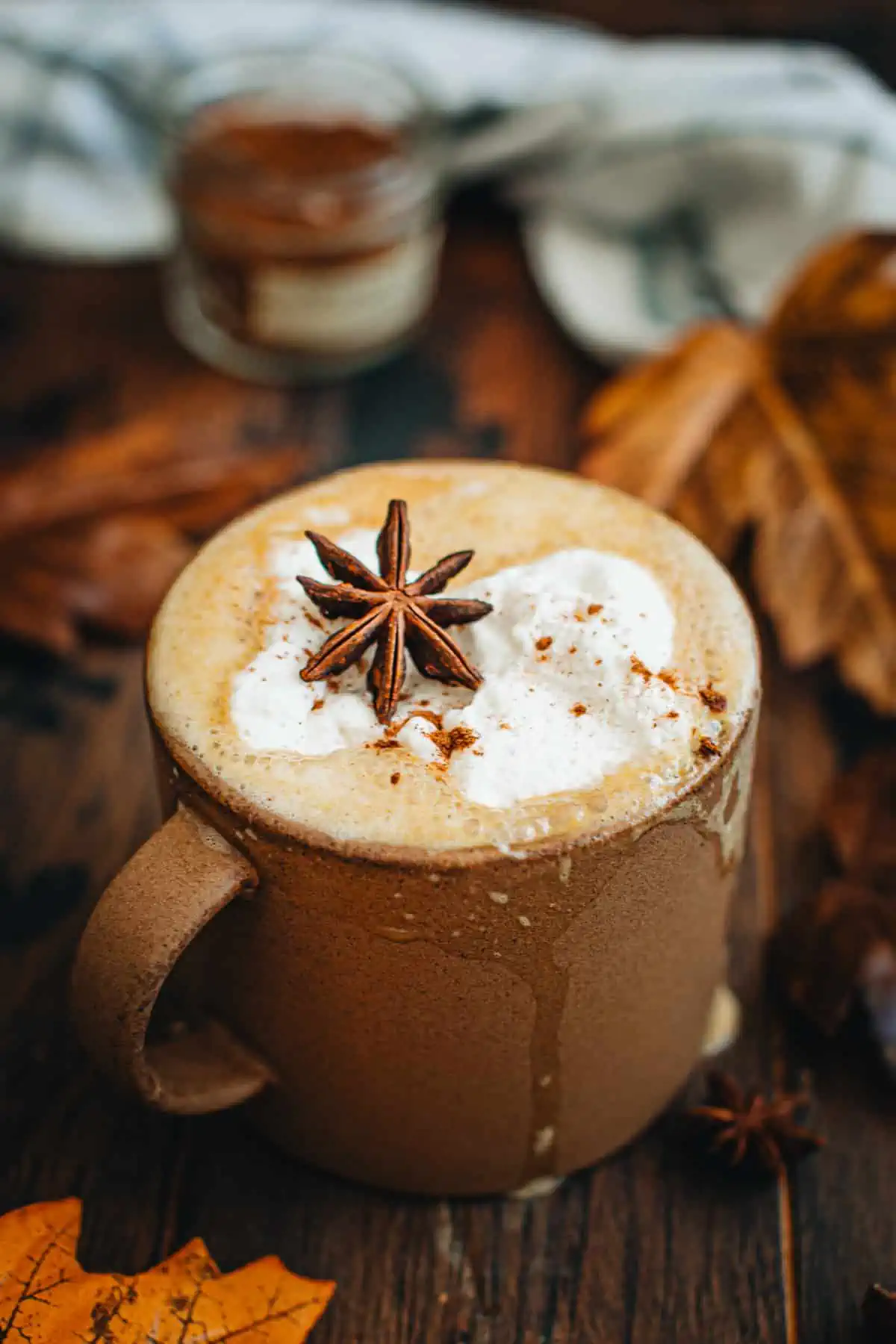 Vegan pumpkin spice latte in a brown mug.