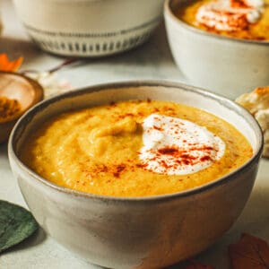 Acorn squash soup with sour cream and paprika sprinkled on top.