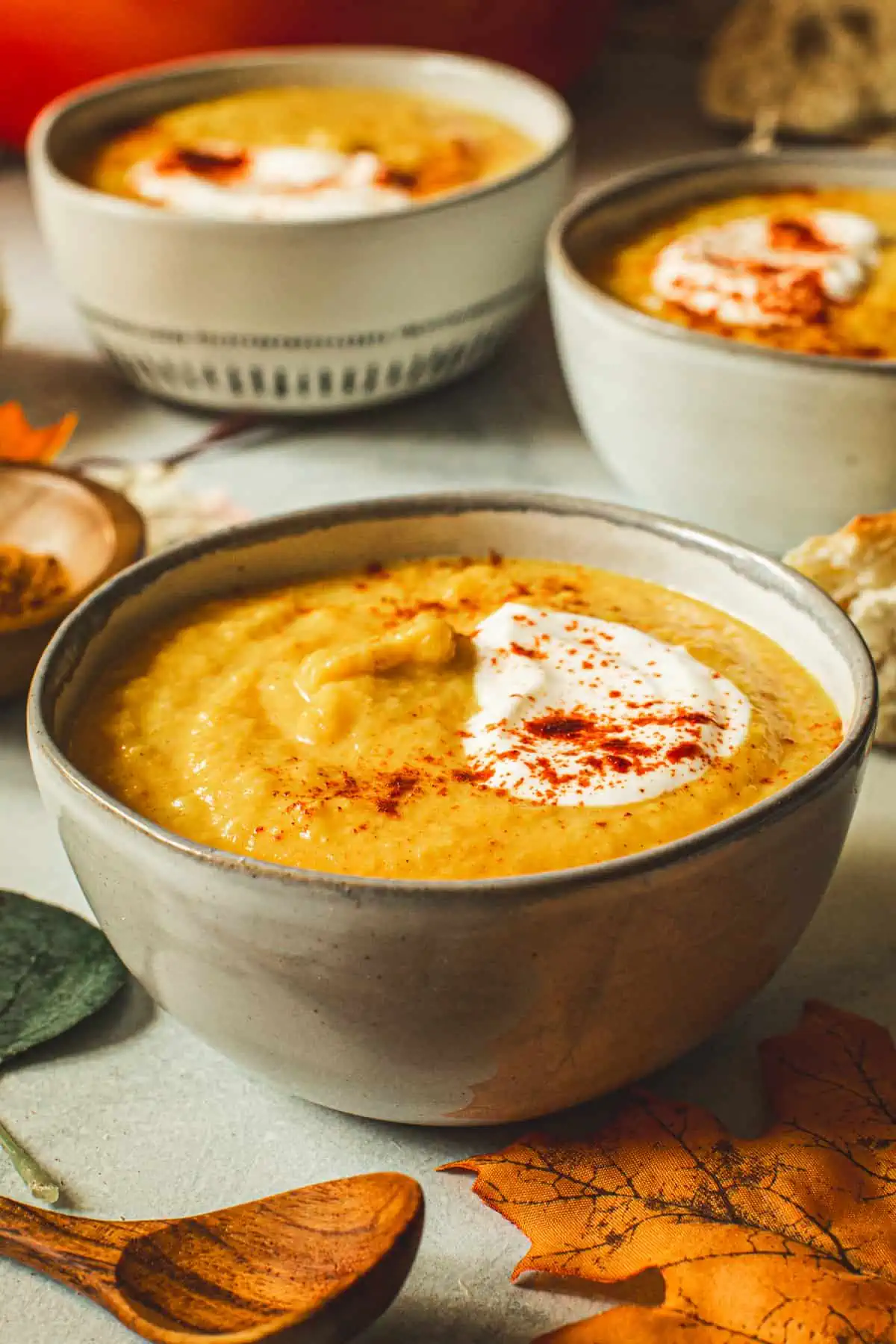 Acorn squash soup topped with sour cream and sprinkled with spices.