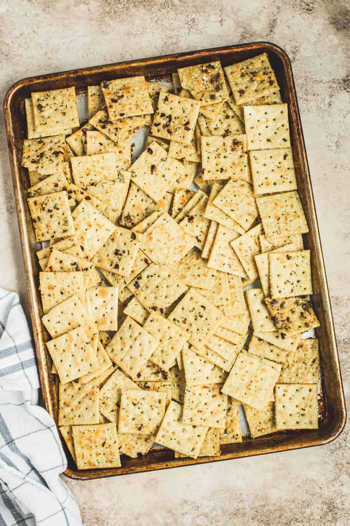 Seasoned crackers spread on a rimmed baking sheet for making Alabama Fire Crackers.