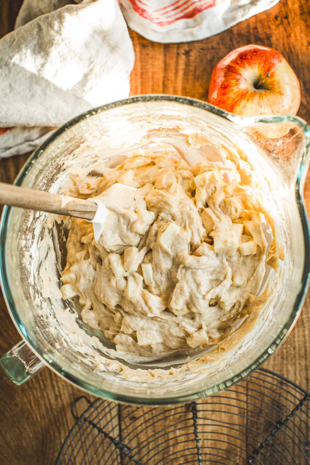 Spatula folding apples into the Apple Cinnamon Muffin batter.