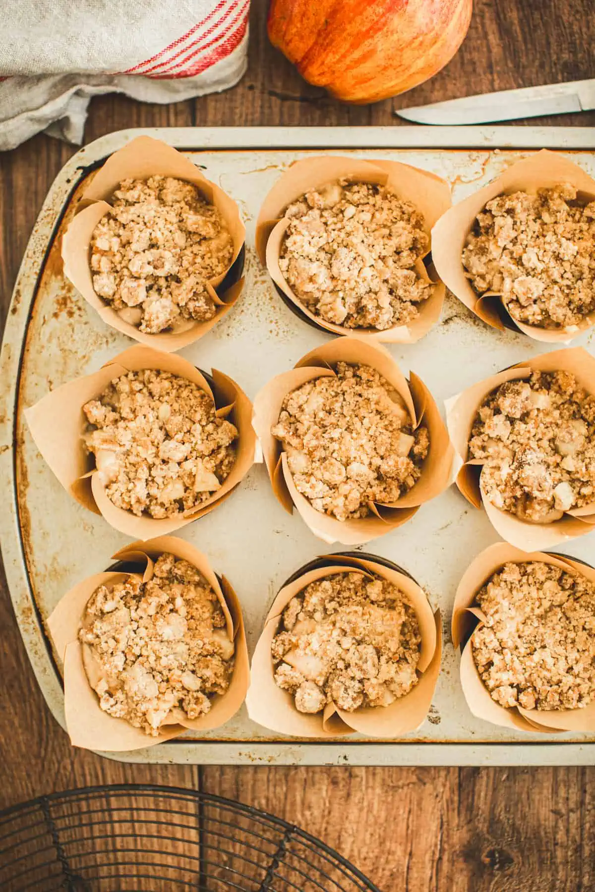 Unbaked apple cinnamon muffins in muffin cups.