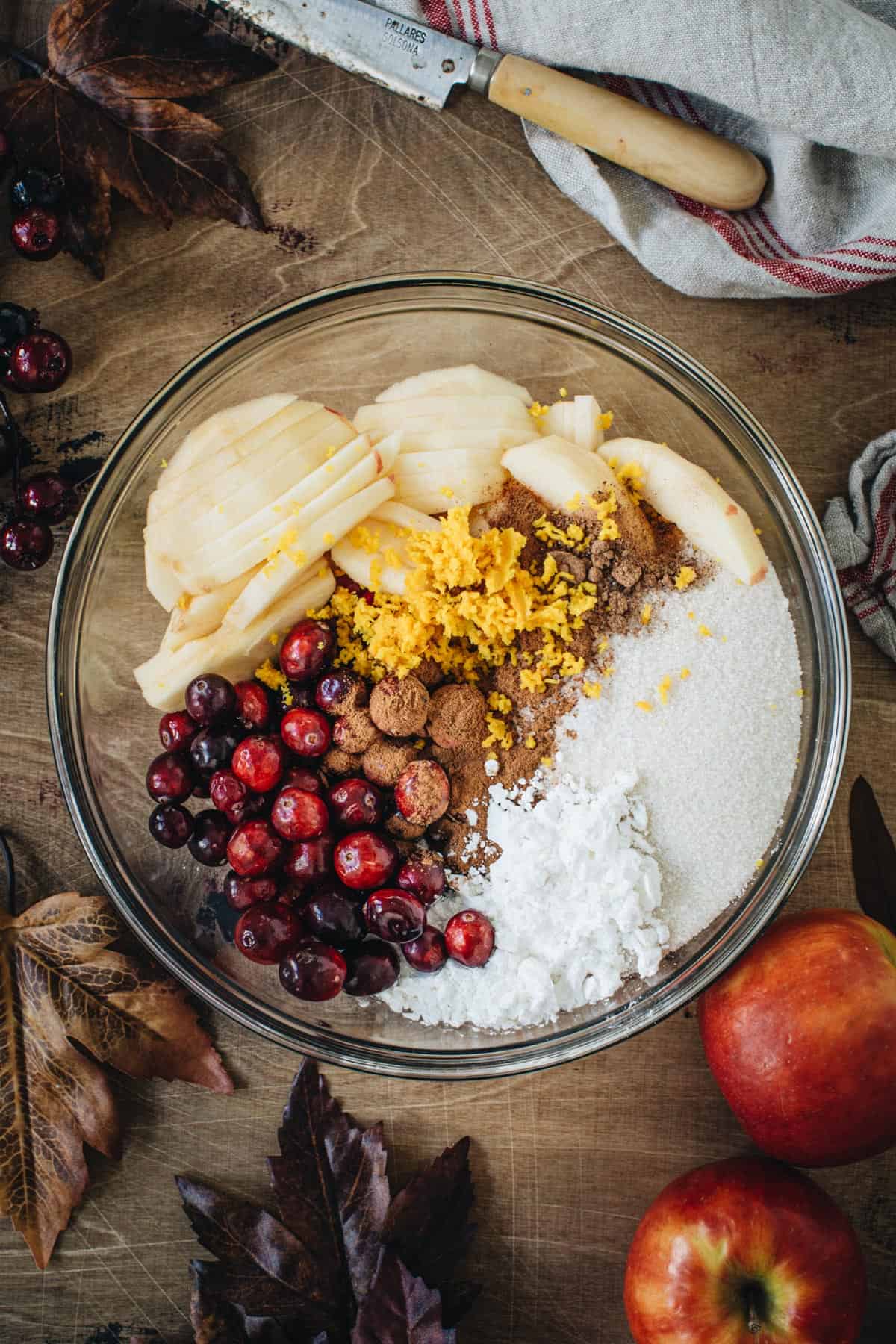 Apple cranberry pie filling ingredients in a mixing bowl.