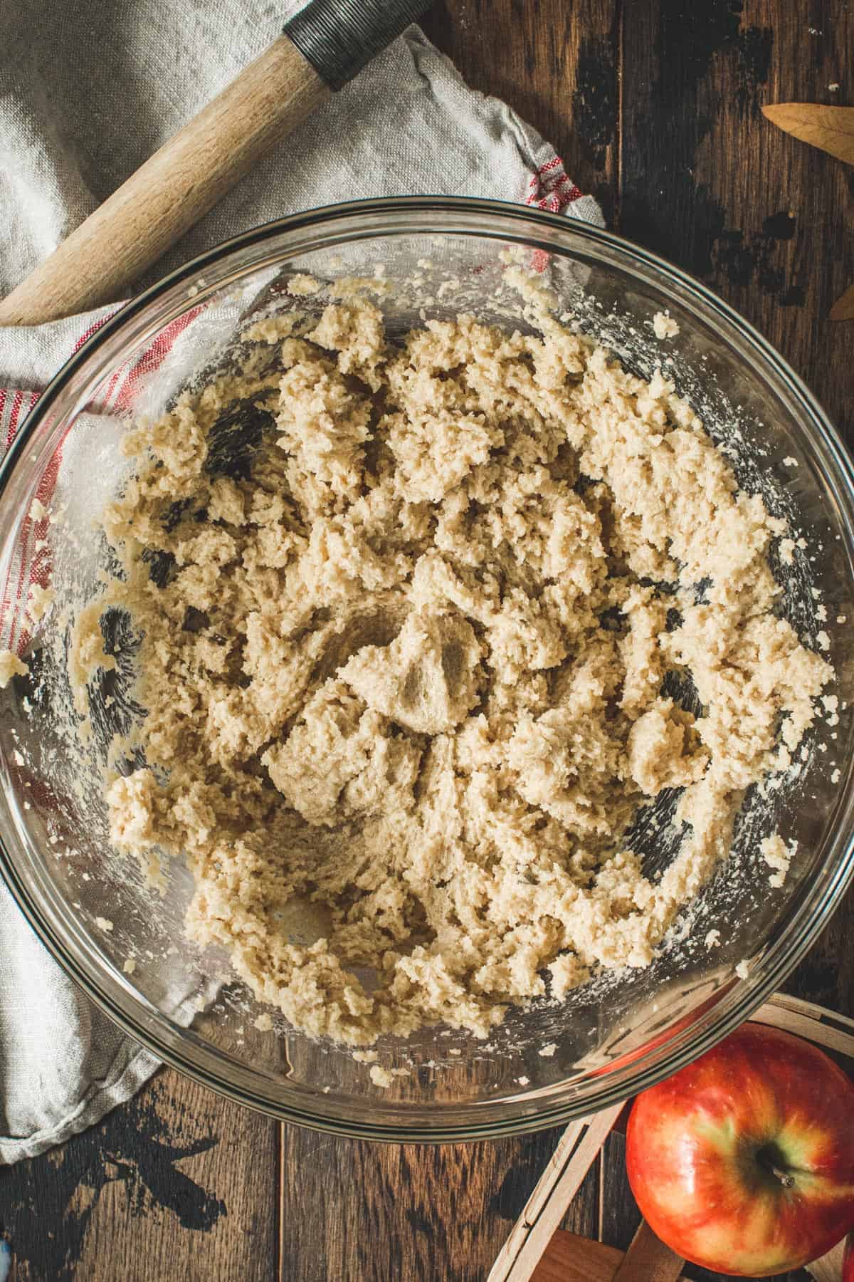 Creamed butter, sugar, and brown sugar for the apple crumb cake in a mixing bowl.