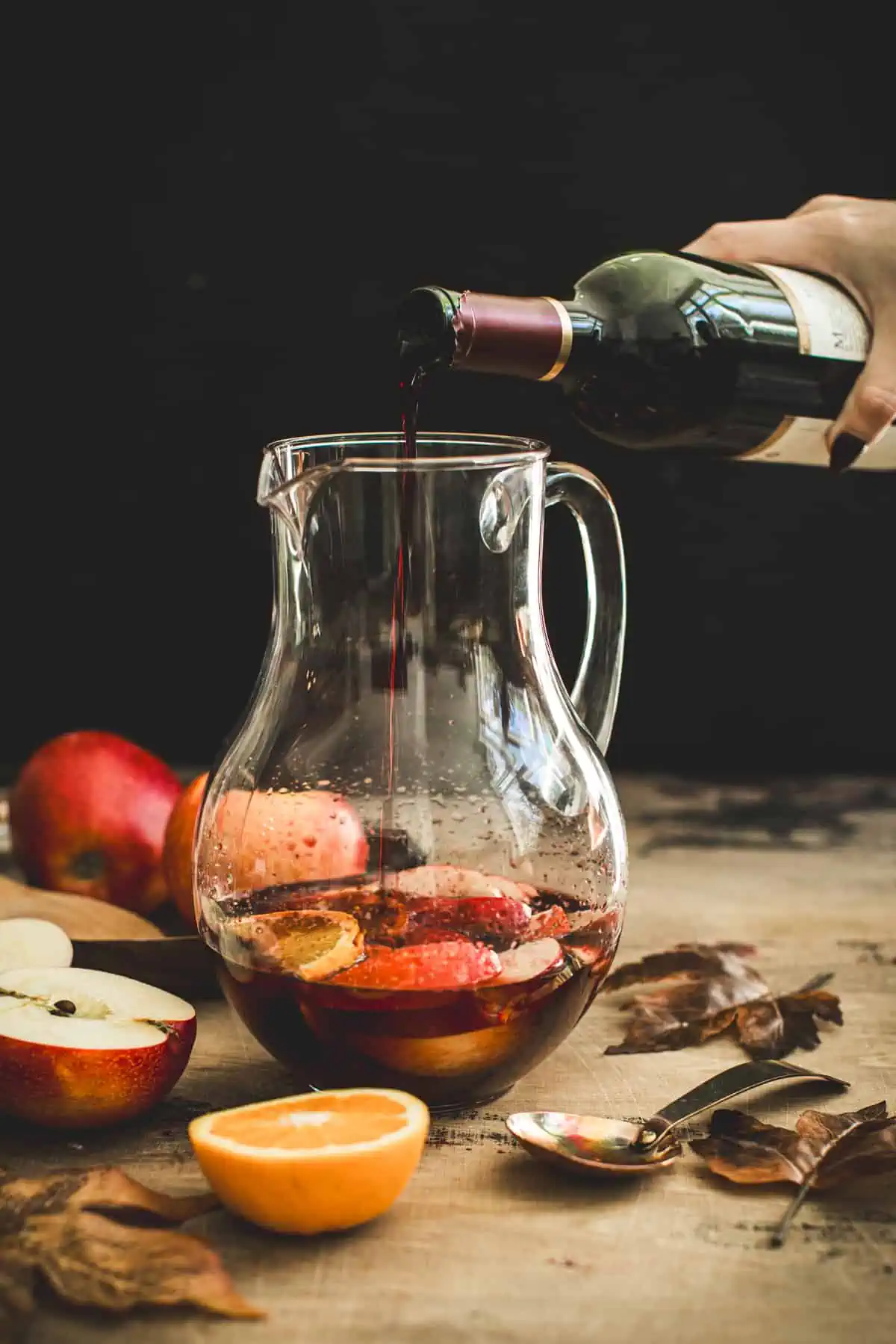 Pour wine into a pitcher for apple sangria.