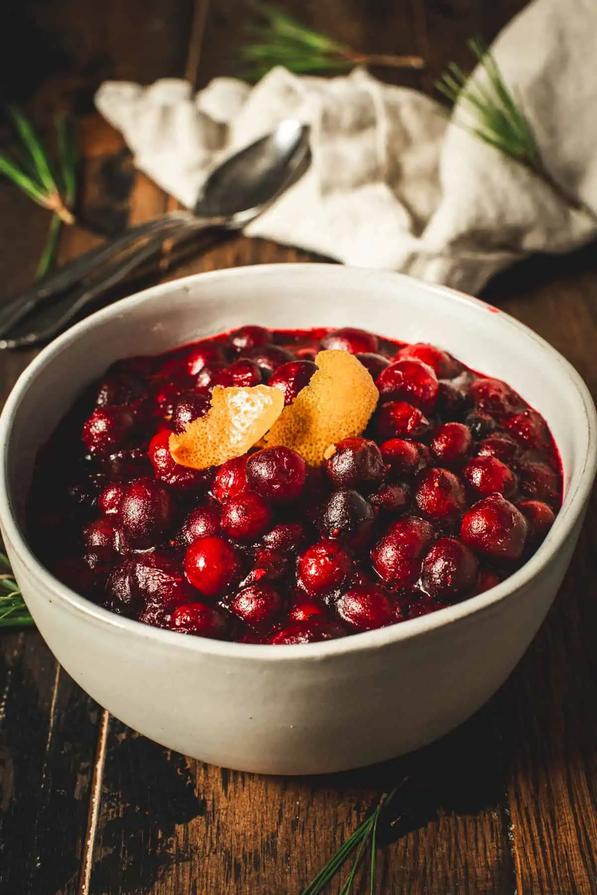 Bourbon cranberry sauce topped with orange peel in a bowl.