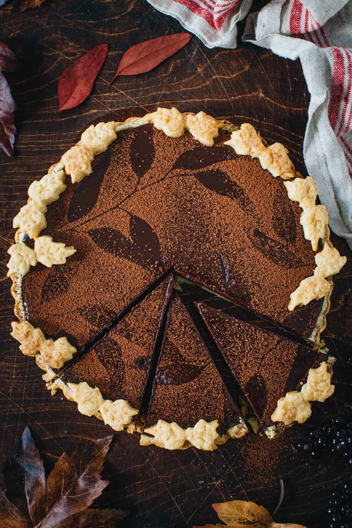 Chocolate tart with slices cut out.