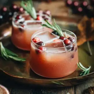 Cranberry Bourbon Cocktail with rosemary and cranberries for garnish.