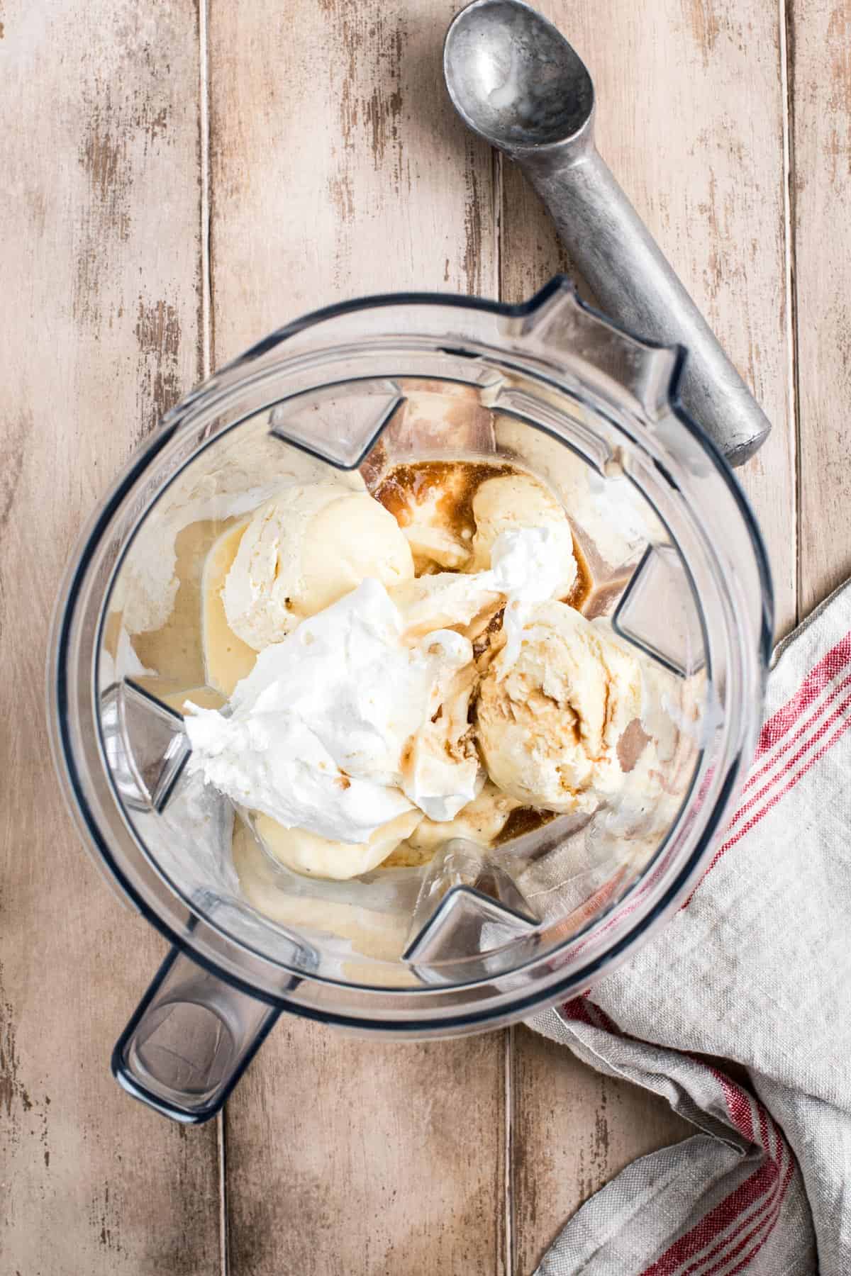 Ingredients for an eggnog milkshake in a blender.