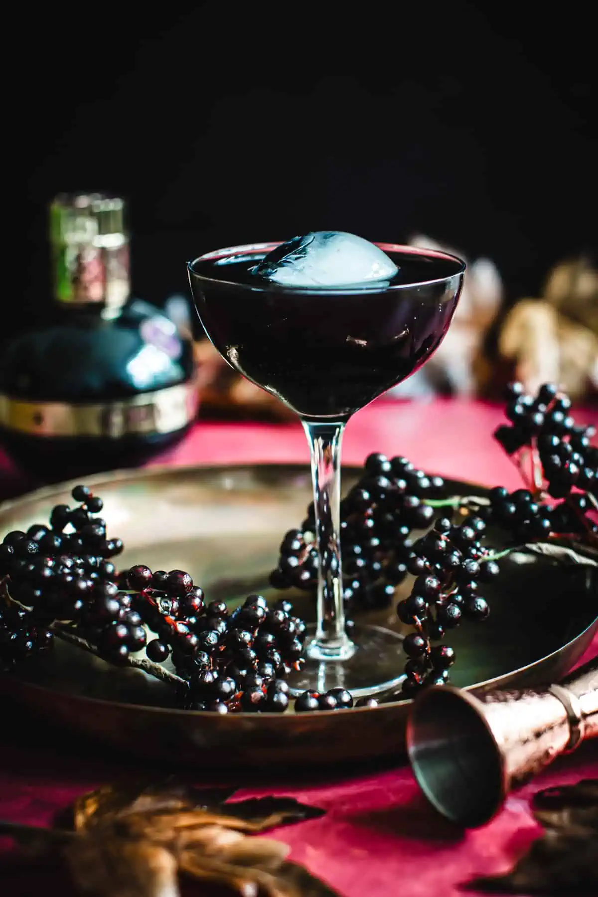 Full Moon Cocktail in a martini glass with an ice sphere for garnish.