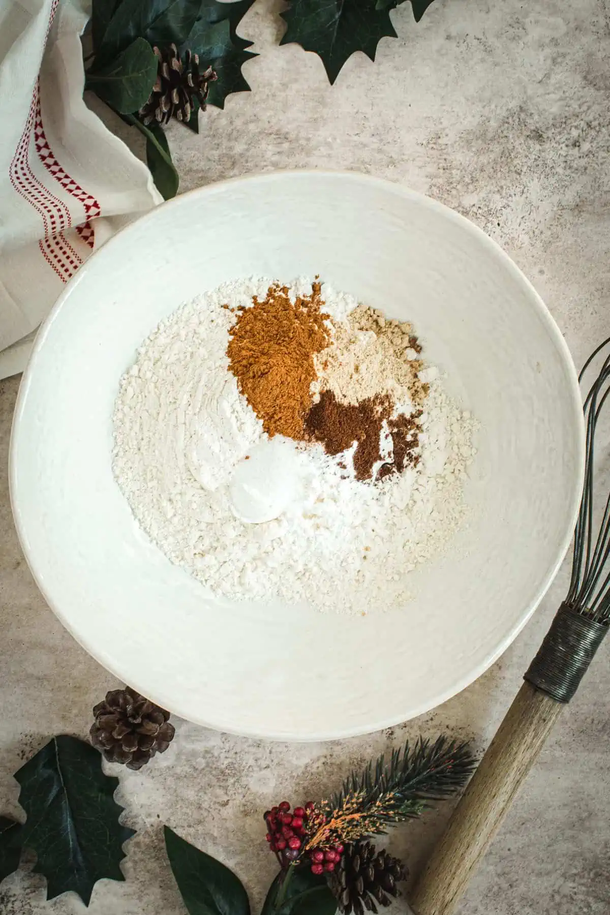 Dry ingredients in a mixing bowl for making gingerbread pancakes.