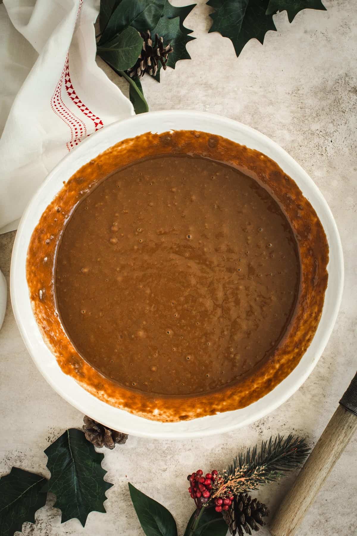 Gingerbread pancake batter in a white mixing bowl.