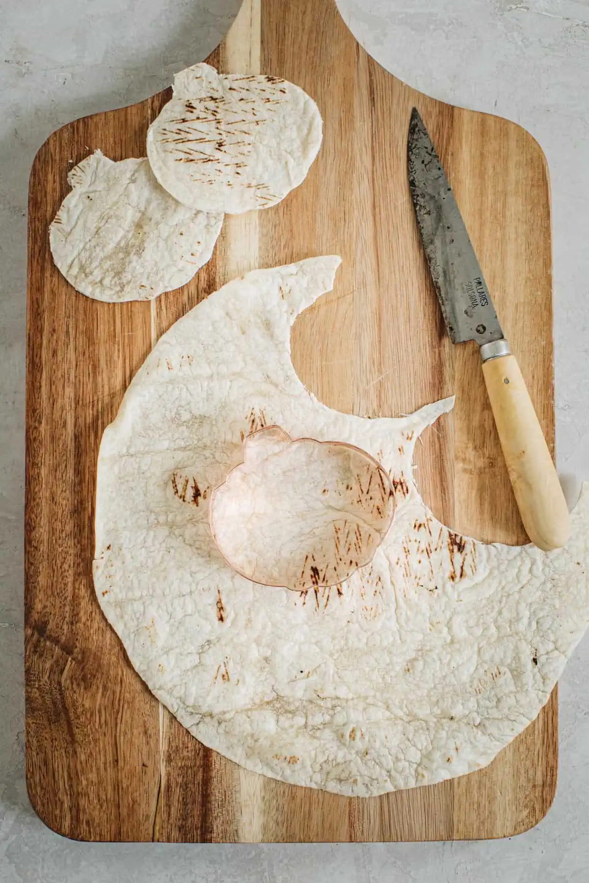 Cookie cutter cutting out a quesadilla for jack-o-lantern quesadillas.