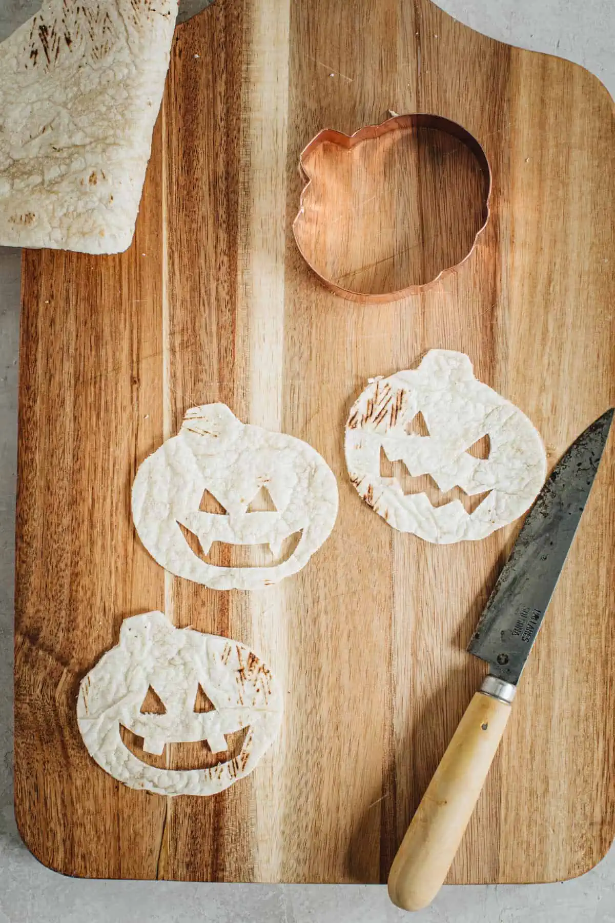 Jack-o-lantern faces cut onto quesadillas for jack-o-lantern quesadialls.