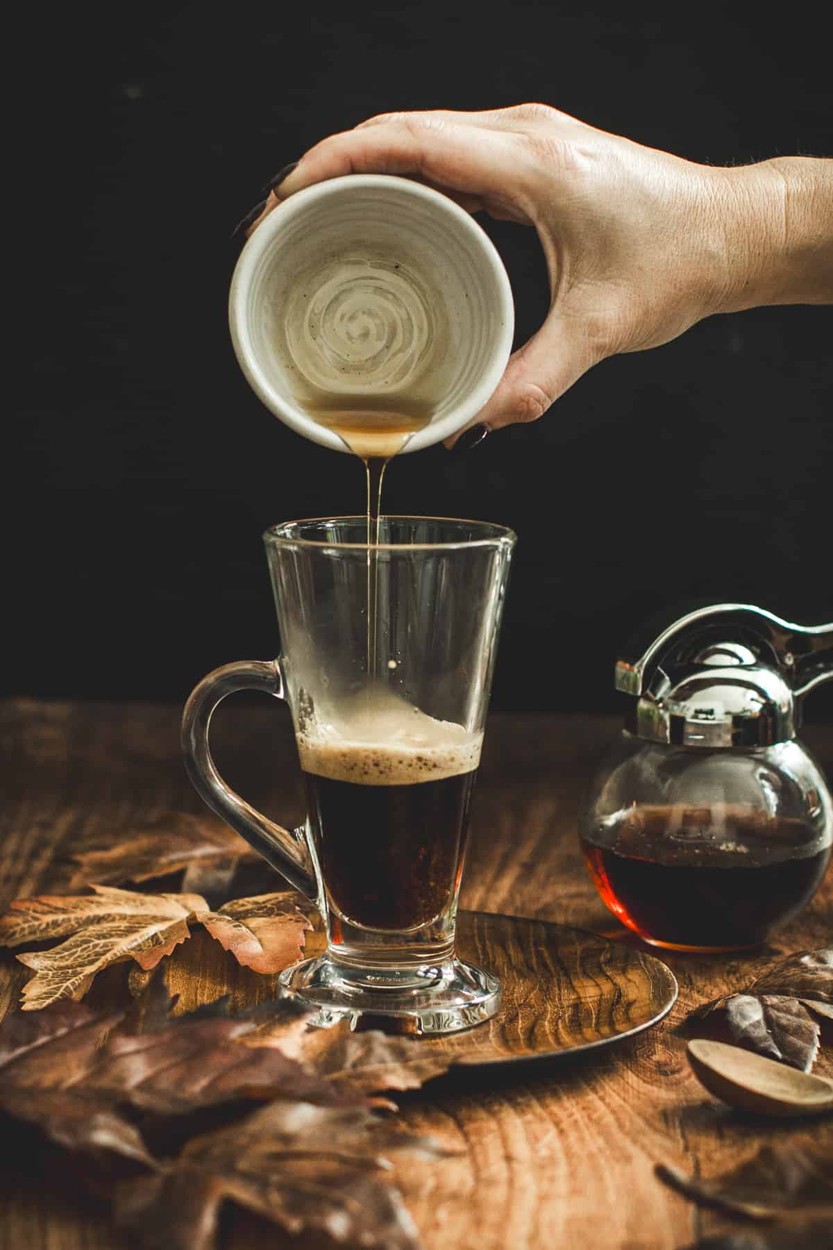 Adding maple syrup to a maple latte.