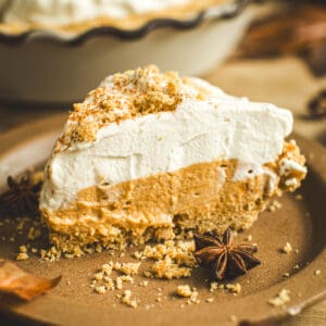 Slice of No-Bake Pumpkin Pie with graham crackers crumbled on top.