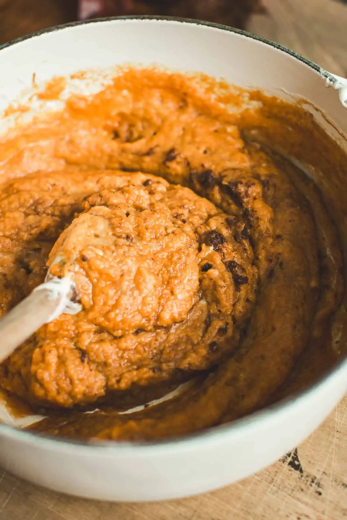 Pumpkin and pumpkin pie spice mixed into melted marshmallows in a pot for No-Bake Pumpkin Pie.