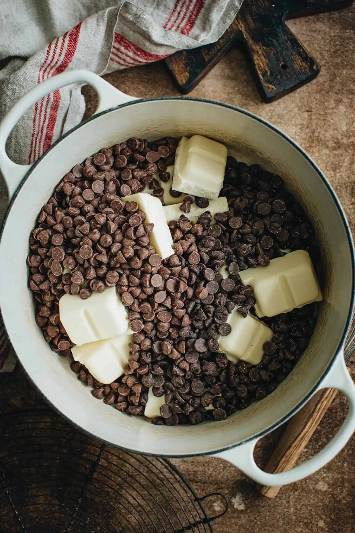 Chocolate chips and almond bark in a large pot for making peanut clusters.