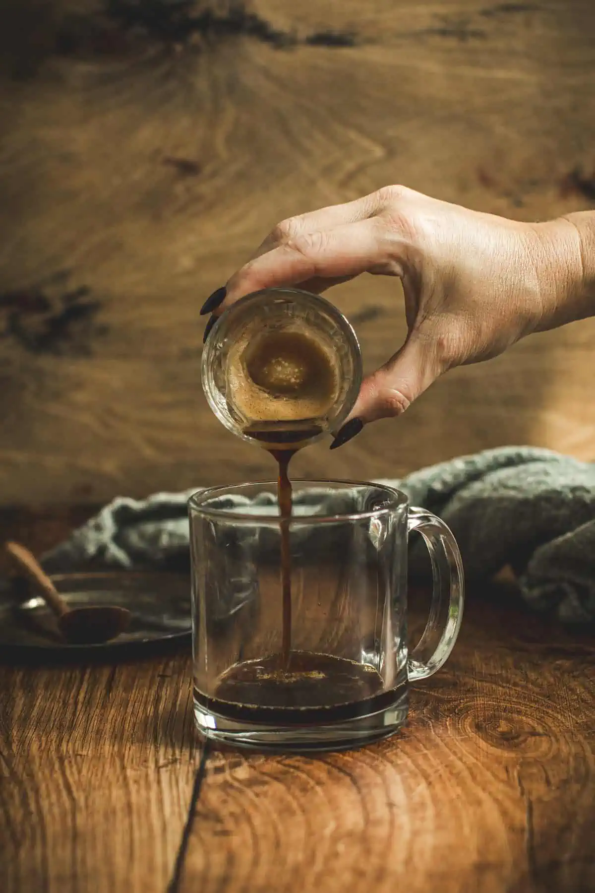 Espresso pouring into a coffee mug.