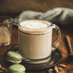 Pistachio latte in a glass coffee mug.