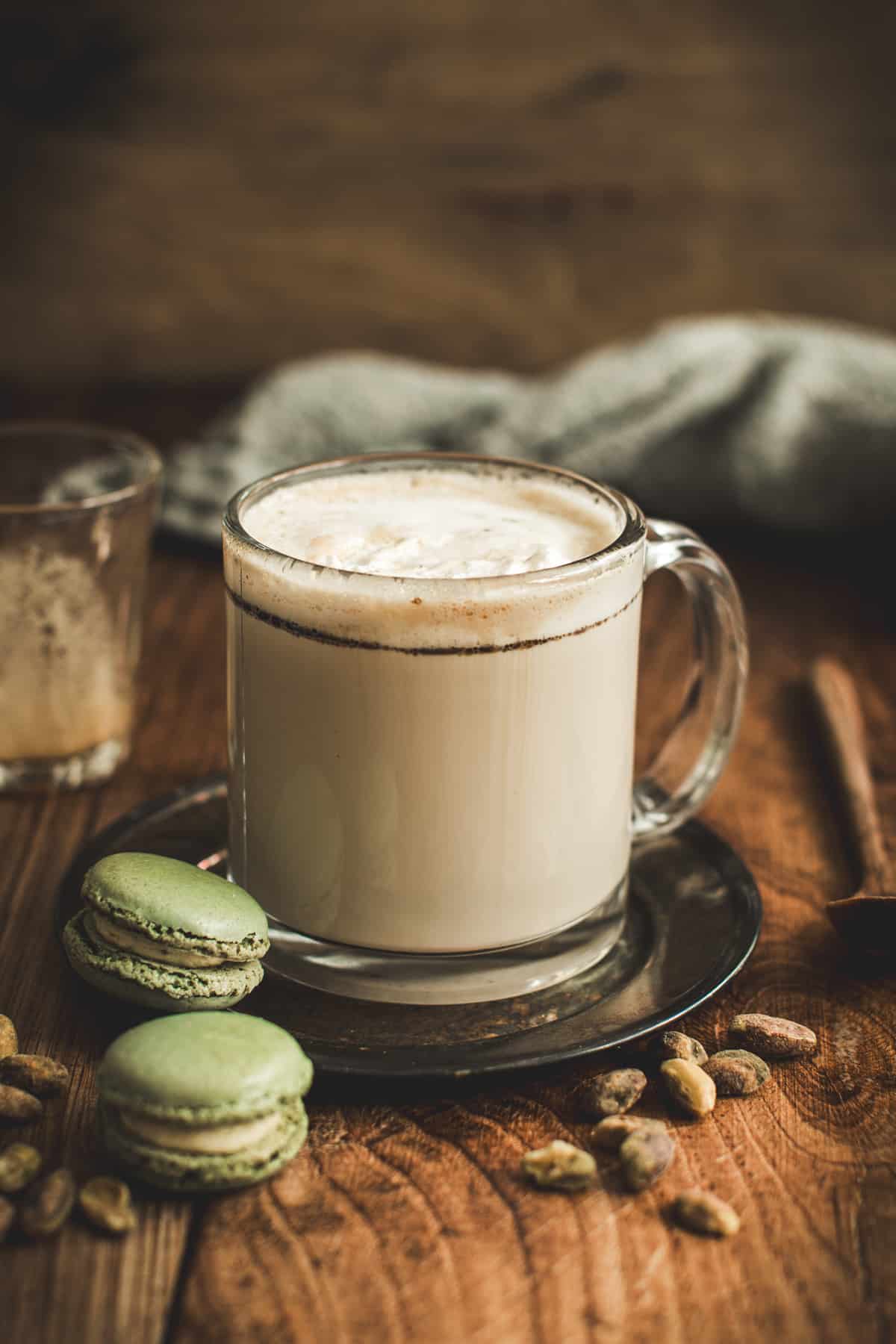 Pistachio latte in a glass mug.