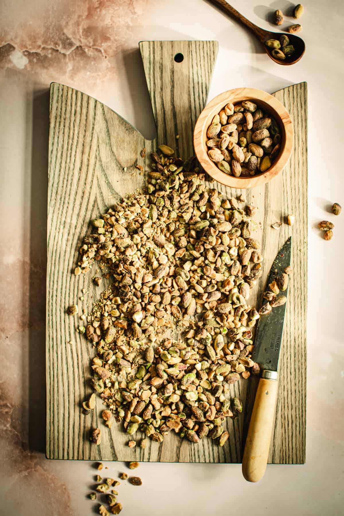 Chopped pistachios on a cutting board.