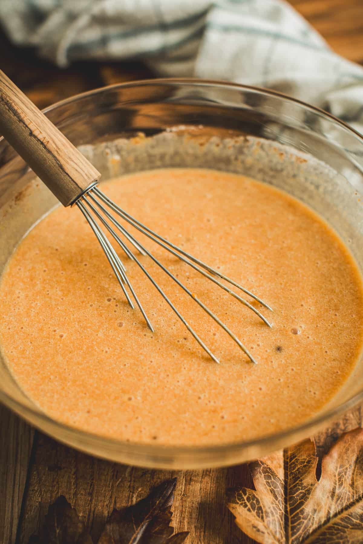 Pumpkin batter in a mixing bowl for Pumpkin Crisp.