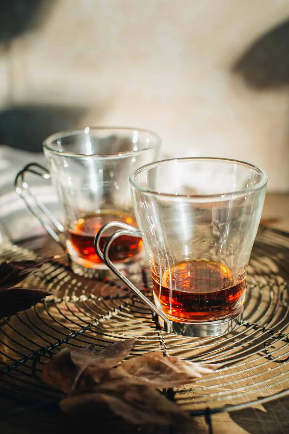 Dark rum in glass mugs for making spiked apple cider.