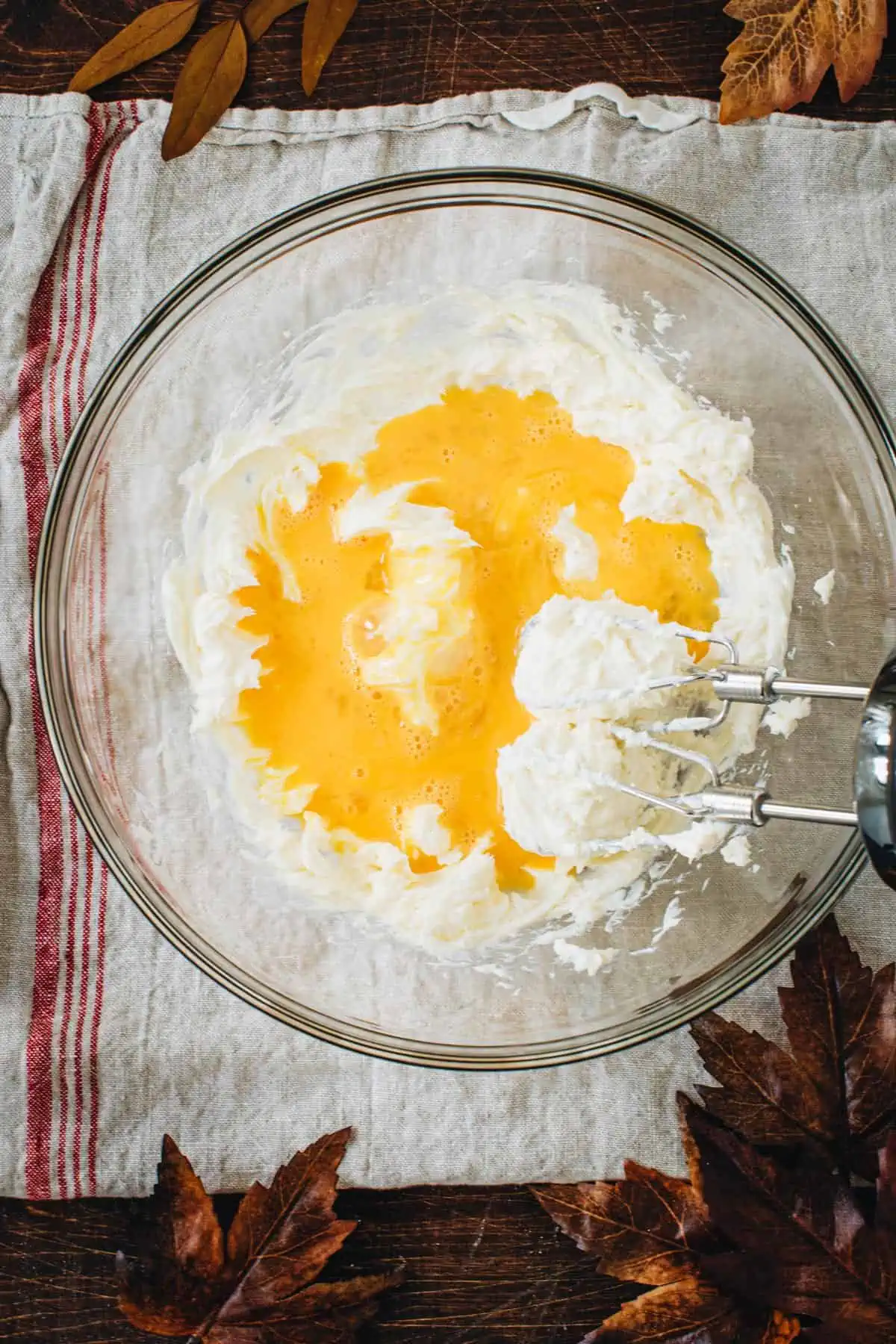 Eggs added to the cream cheese mixture for making spoon bread.