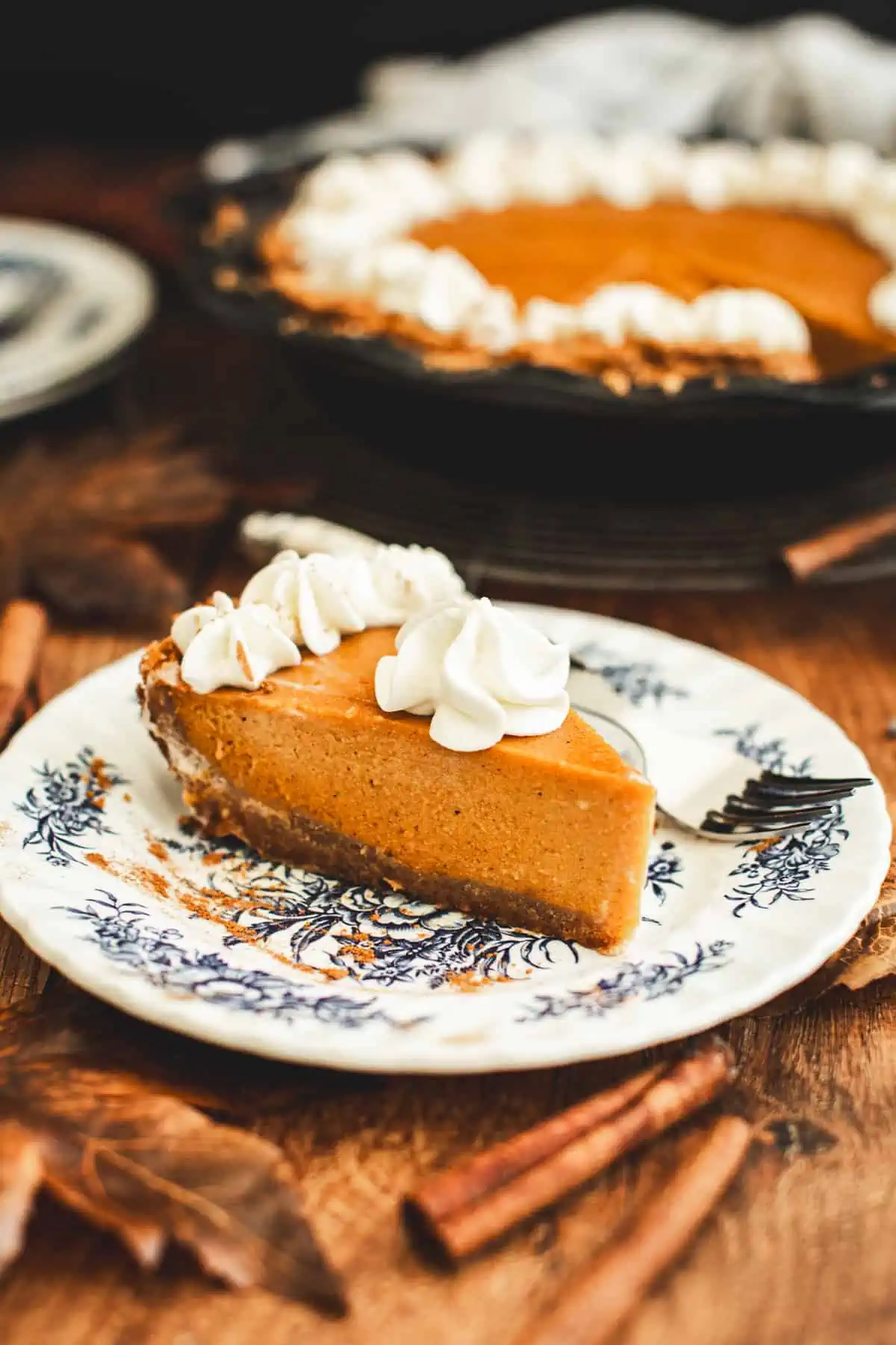 Slice of sweet potato pie in graham cracker crust.