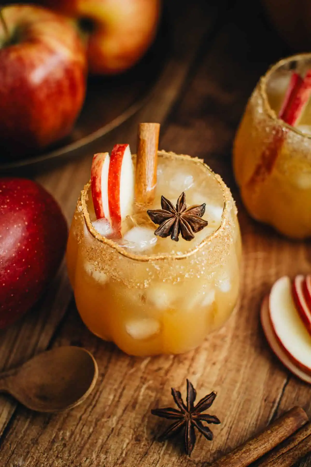 Thanksgiving punch in a glass with apple slices, cinnamon stick and star anise for garnish.