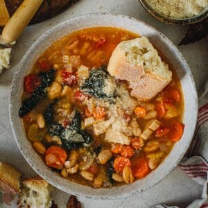 Tuscan white bean soup with crusty bread and grated parmesan on top.