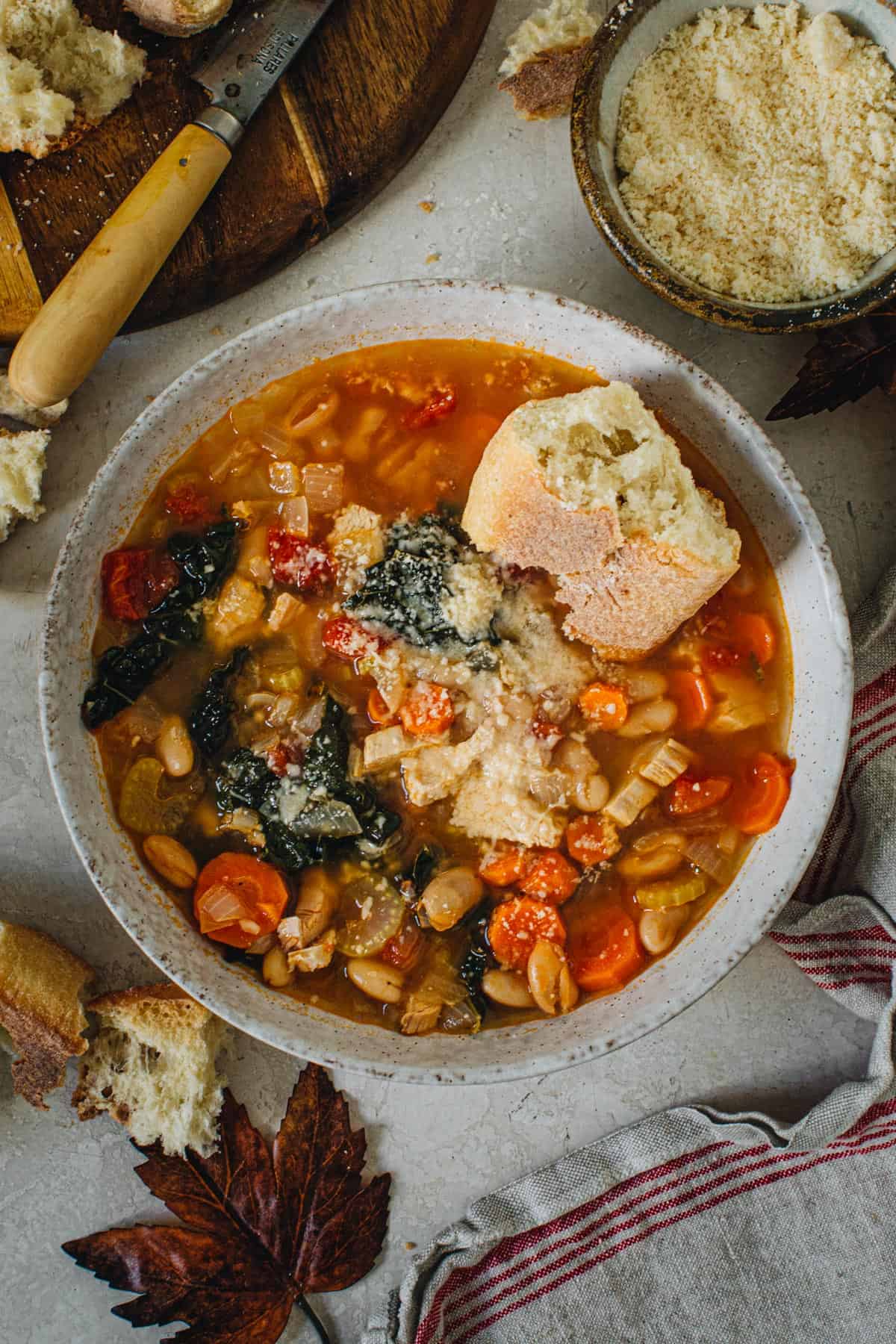 Tuscan white bean soup with crusty bread and grated parmesan on top.