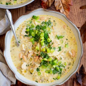 White turkey chili in a bowl topped with fresh cilantro and green onions.