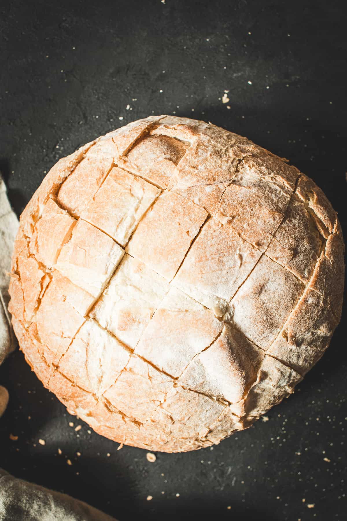 Sliced sourdough bread for making cranberry brie pull-apart bread.