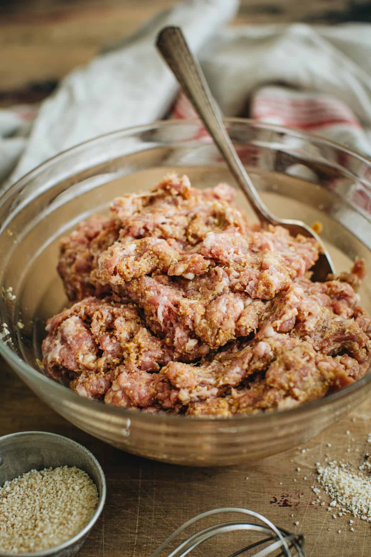 Meatball ingredients combined in a mixing bowl and ready to be shaped into meatballs for making cranberry meatballs.