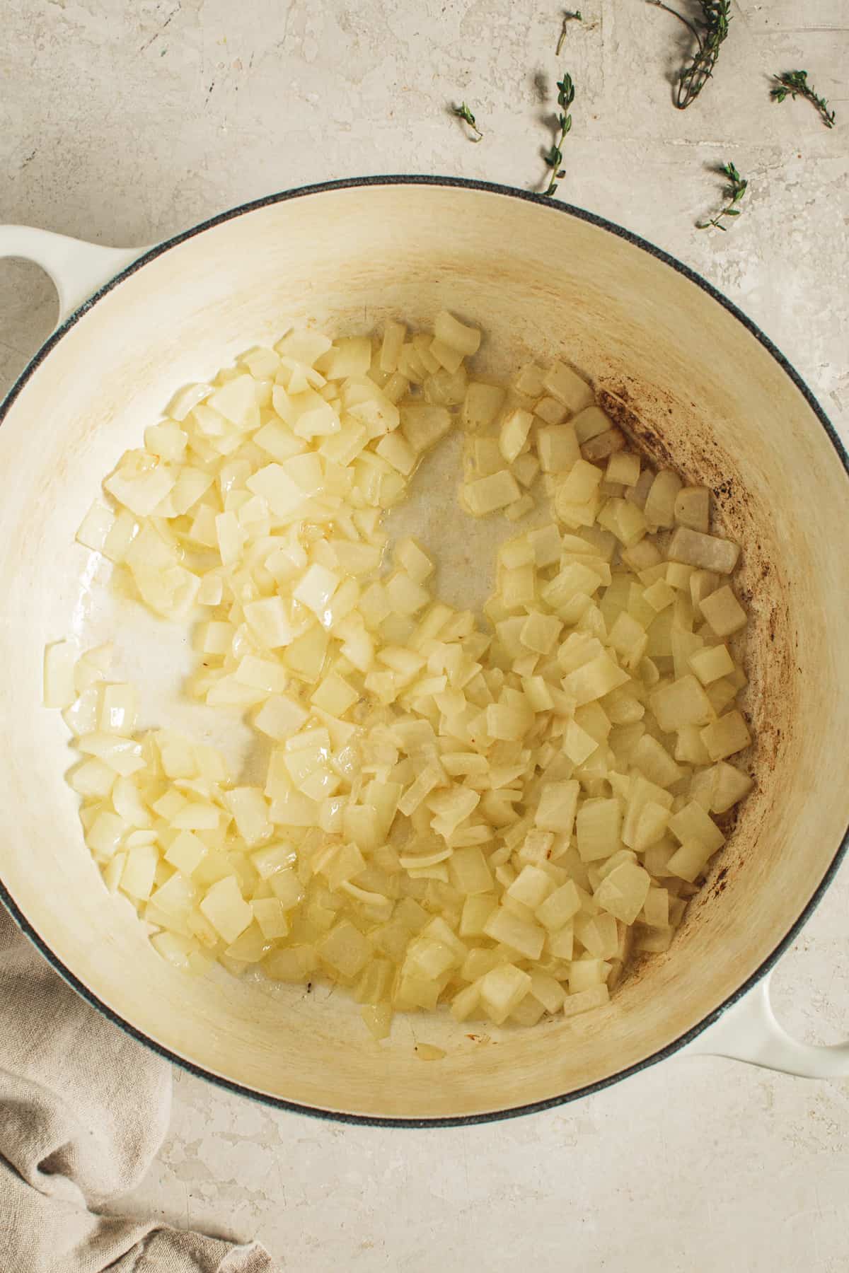 Onions sautéed in butter in a large white pot for making creamed corn.