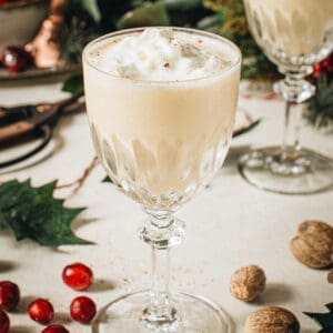 Eggnog martini topped with whipped cream and nutmeg.