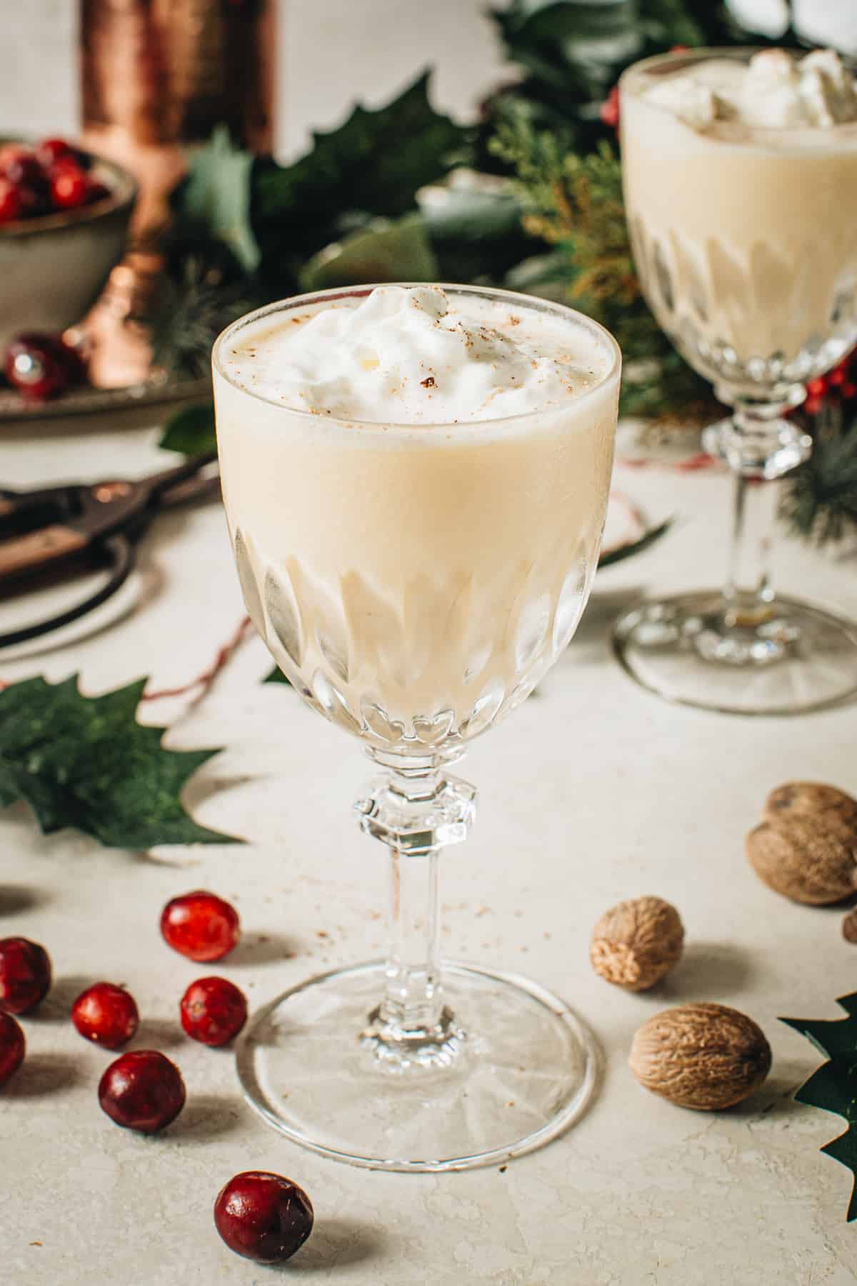 Eggnog martini topped with whipped cream and nutmeg.