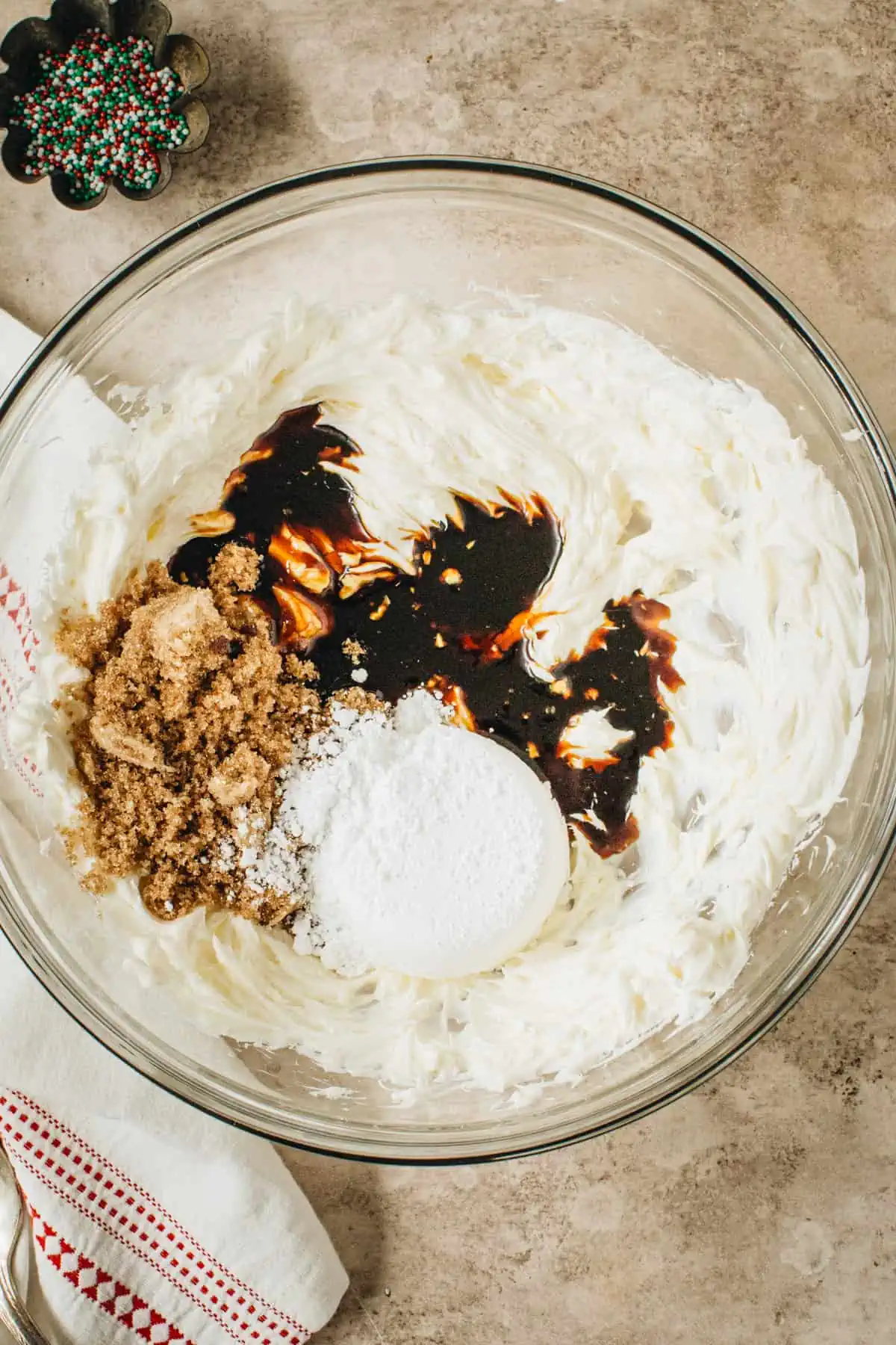 Flavorings added to the cream cheese in a mixing bowl for making gingerbread dip.