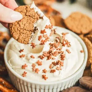 Gingersnap dipping into gingerbread dip topped with gingerbread man sprinkles.