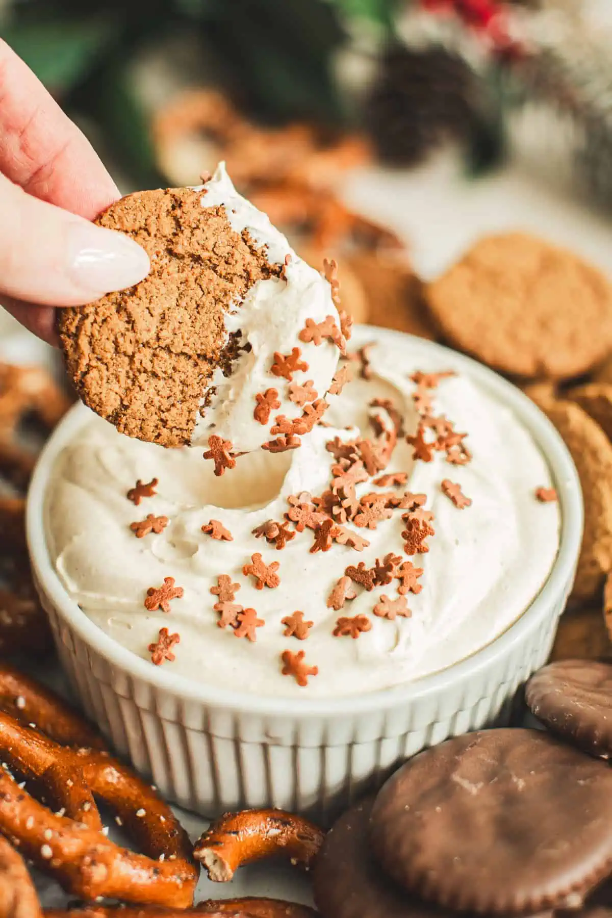 Gingersnap dipped into Gingerbread Dip with gingerbread man sprinkles on top.