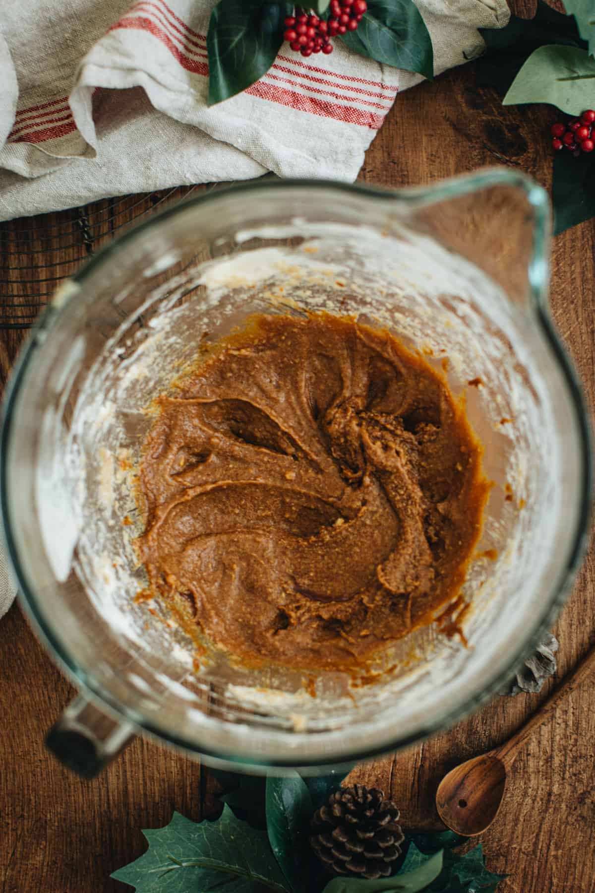 Wet ingredients mixed into the creamed butter and sugar in a mixing bowl for making gingerbread loaf.