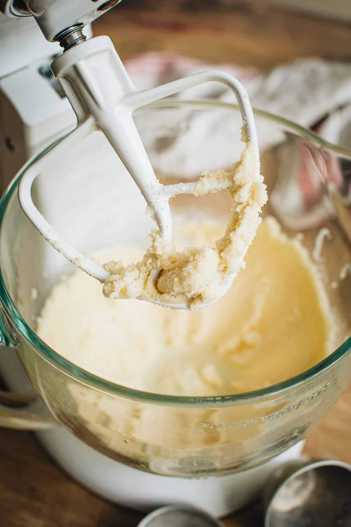 Creamed butter and sugar on the paddle of an electric mixer for making jalapeño cornbread.