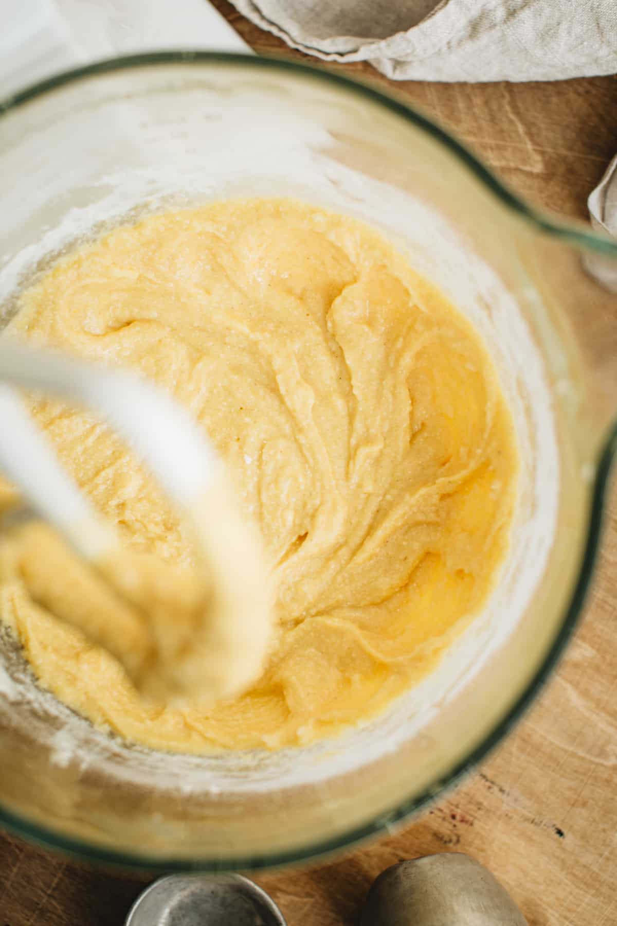 Batter in the bowl of an electric mixer for making jalapeño cornbread.