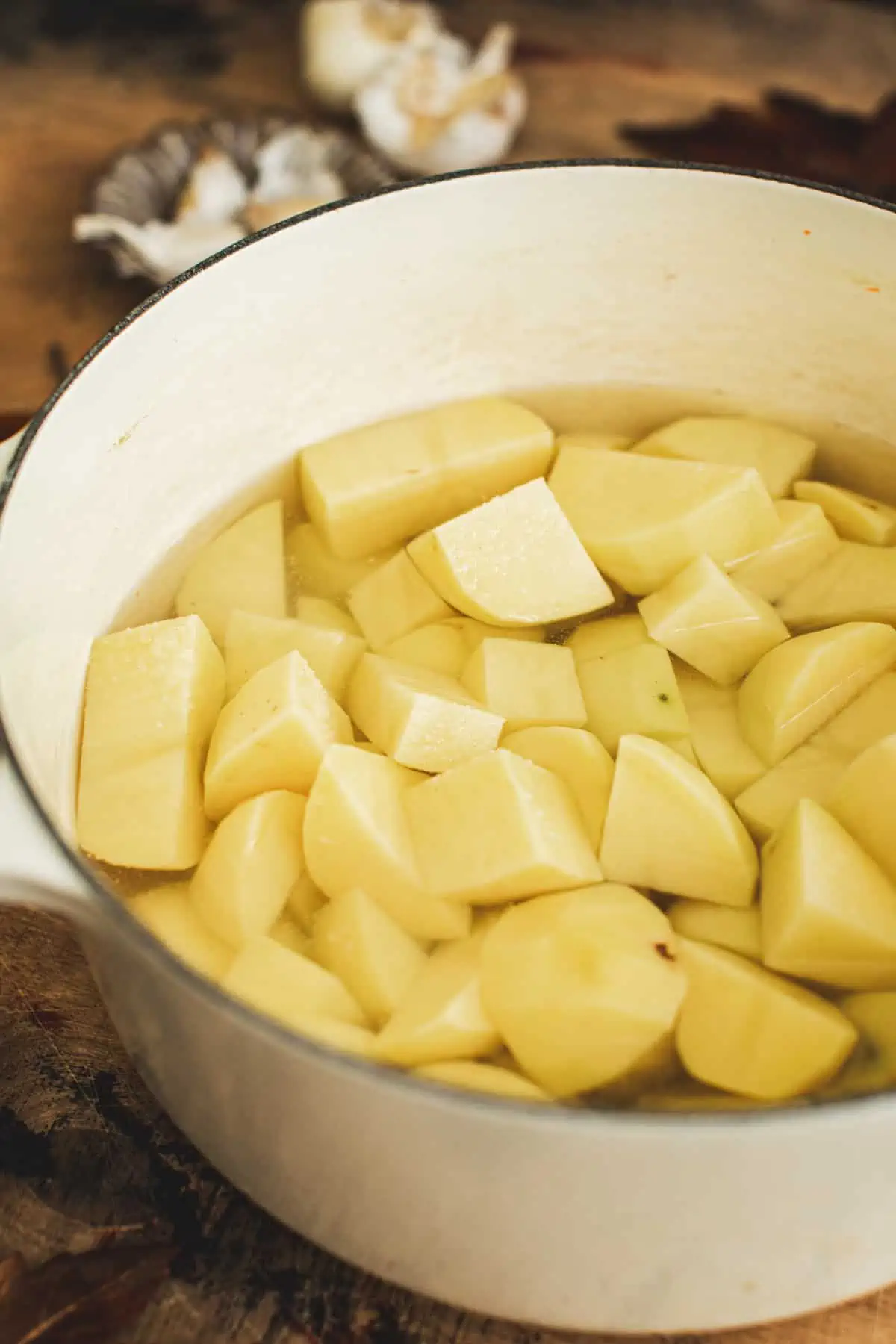 Diced potatoes in water for making mashed potatoes with truffle.