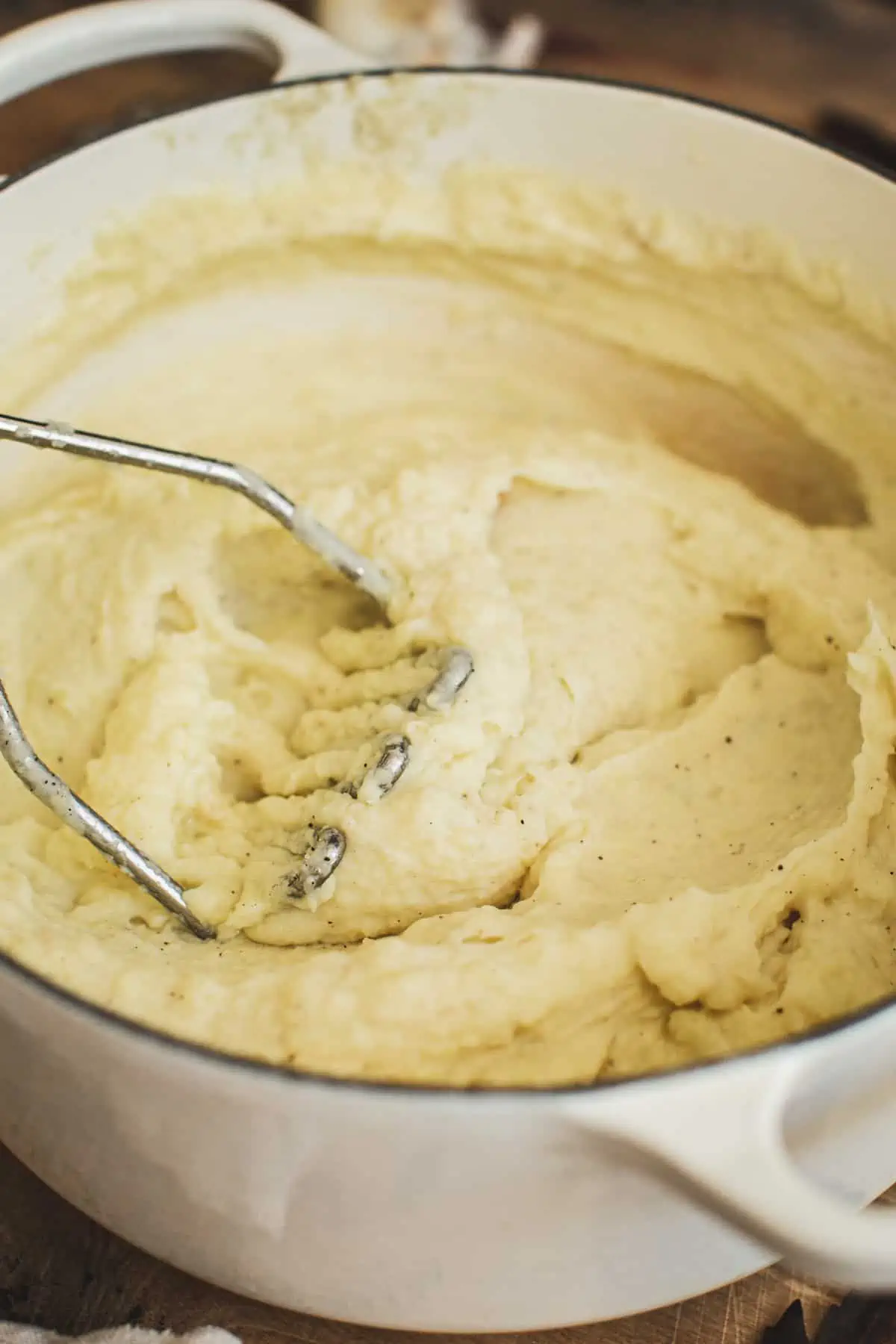 Potato masher mashing potatoes for making mashed potatoes with truffle.