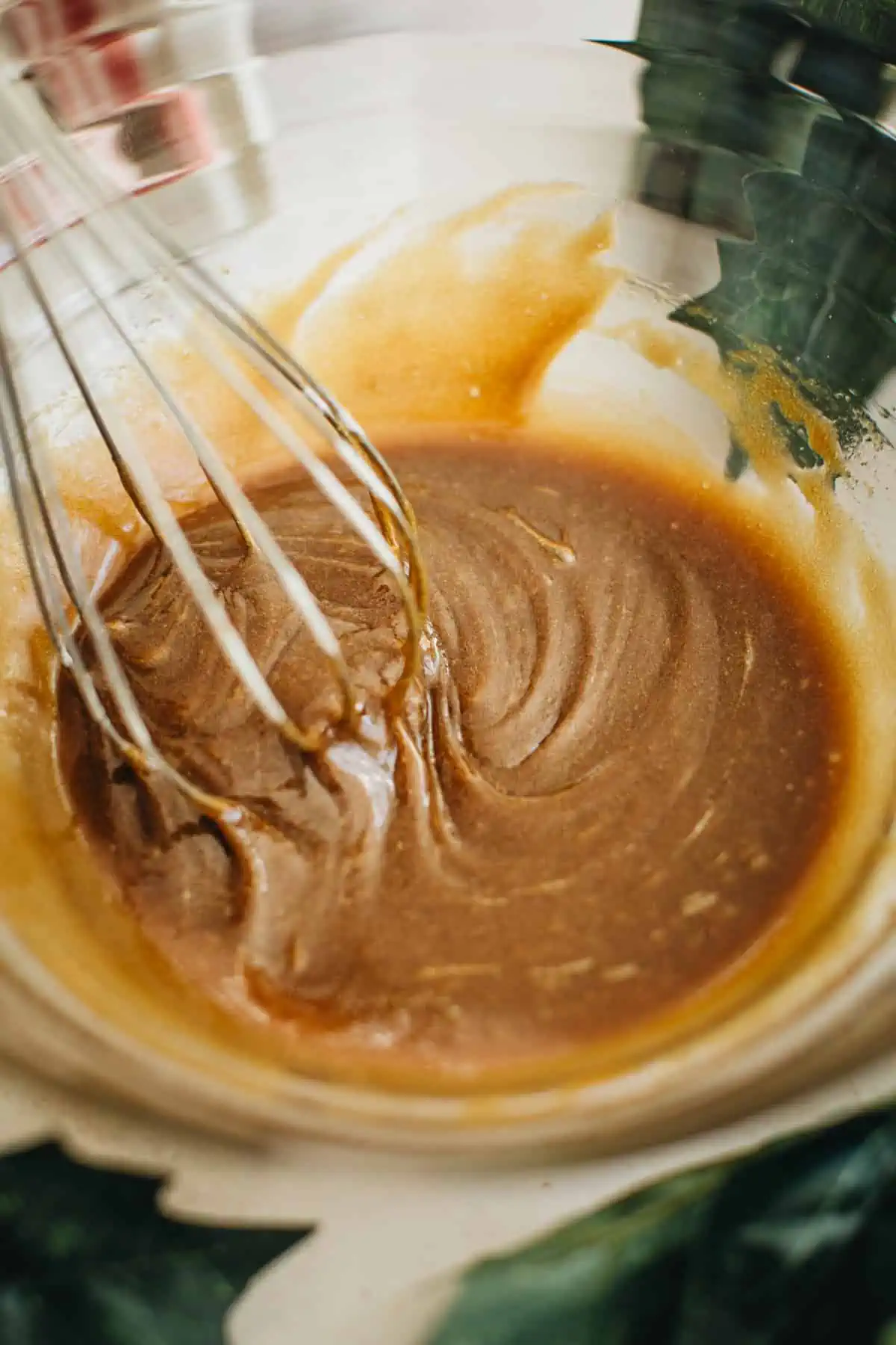 Wet ingredient mixture in a mixing bowl for making Molasses Crinkle Cookies.