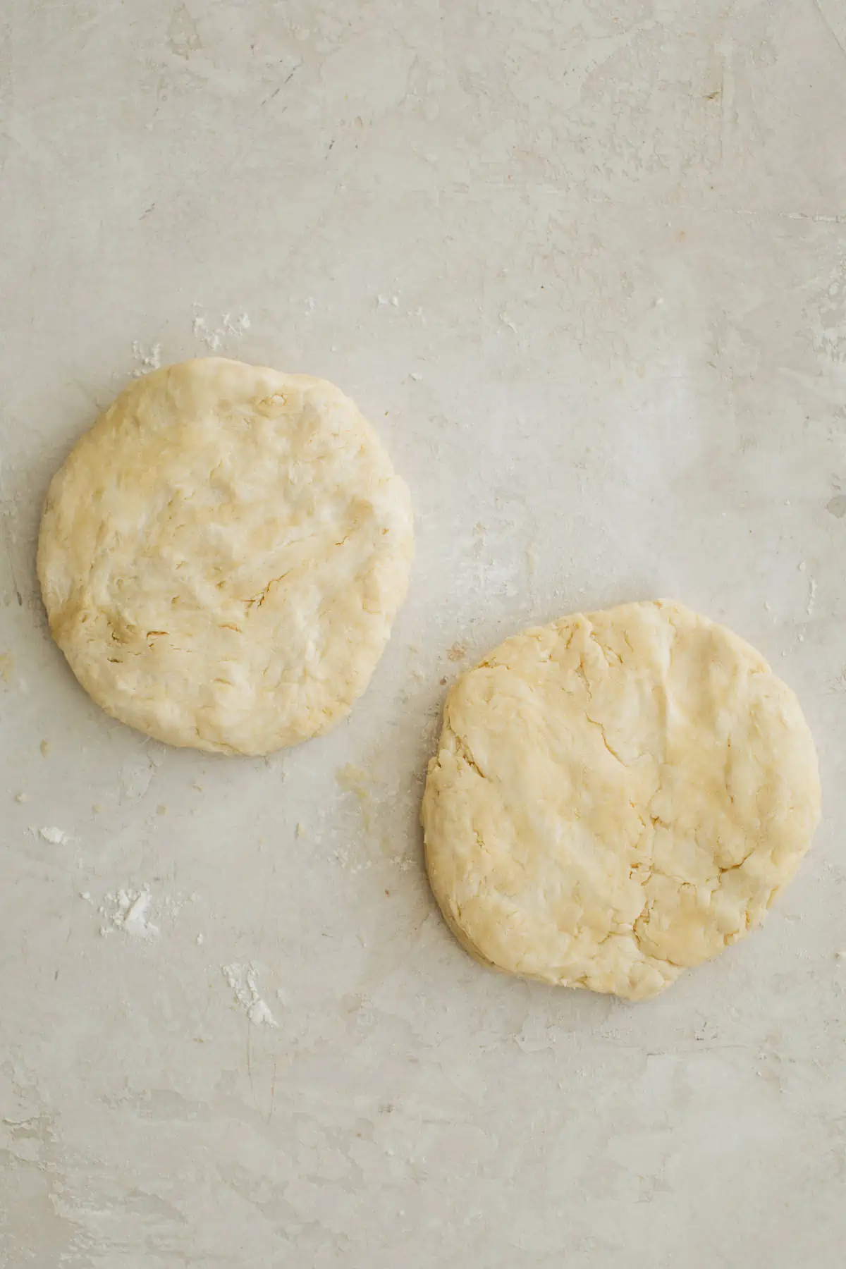 Two pie crusts with shortening and butter shaped into discs.